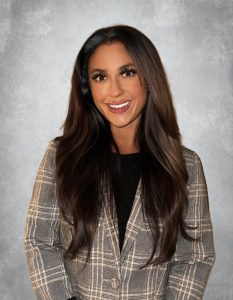 Portrait of female dental team member smiling in professional business attire