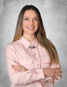 Portrait of Silviya Ivanova, DMD smiling with arms crossed in professional attire