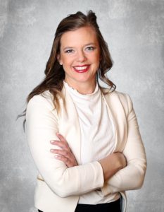 Portrait of Samantha Kufta, DDS smiling in professional attire with arms crossed