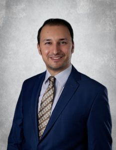 Portrait of Abdelrahman Salem, Orthodontist in a blue suit and tie