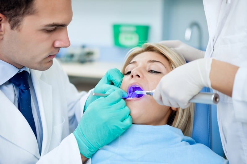 Dentist using advanced dental technology during a patient treatment procedure