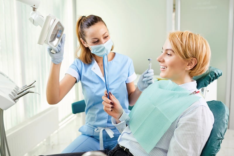 New dental patient consulting with dentist during office visit